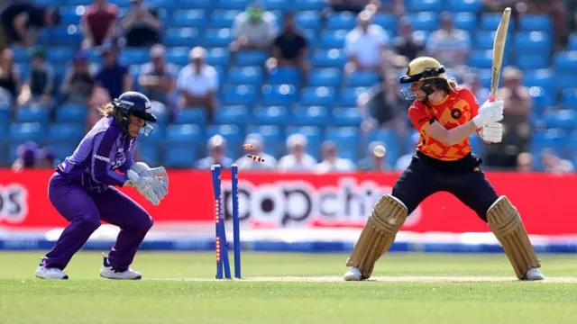 Marie Kelly looks back at her stumps after being bowled.