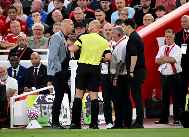 Anthony Taylor trots off to the touchline to speak to both managers