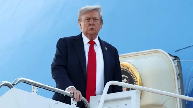 Trump wears a suit and boards Air Force One.