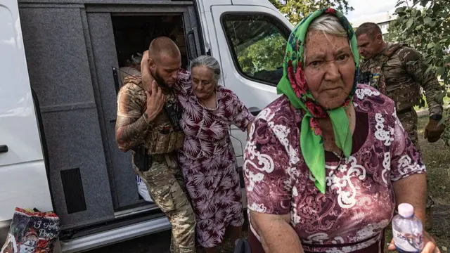 The 'White Angels' police group evacuates civilians from the village of Bilytske, following the advance of Russian troops, in the Donetsk Oblast, Ukraine, 13 August 2025