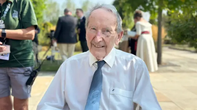 Stan wears a shirt and tie