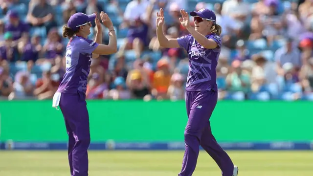 Annabel Sutherland and Kate Cross celebrate taking the wicket of Emma Lamb