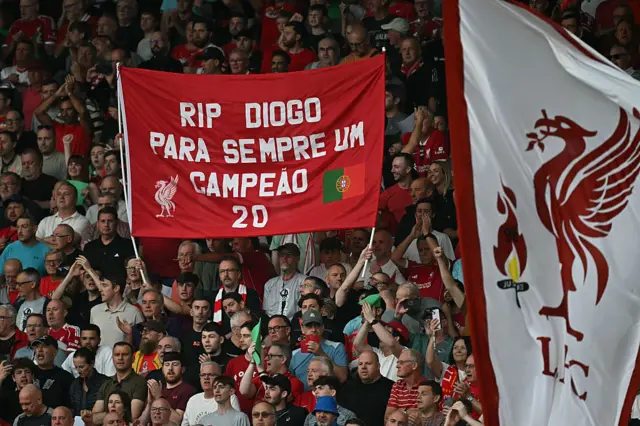 Fan holds up banner with Rest in peace Diogo. A champion forever in his native Portuguese