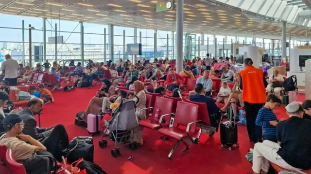 Passengers waiting at Paris Charles de Gaulle airport