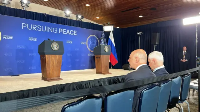 Both Russian minsters are seen sitting in the front row, with two empty podiums in front of them