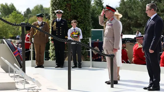 King Charles salutes next to Keir Starmer