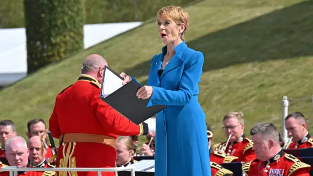 Celia Imrie reading in a blue jacket