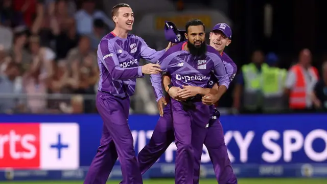 Adil Rashid celebrates with teammates after taking a wicket
