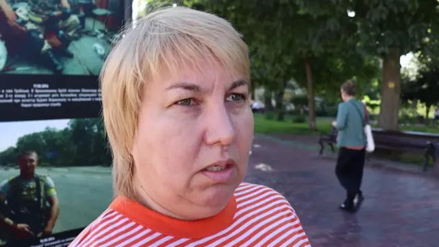 Blonde haired woman wearing a striped red and white top