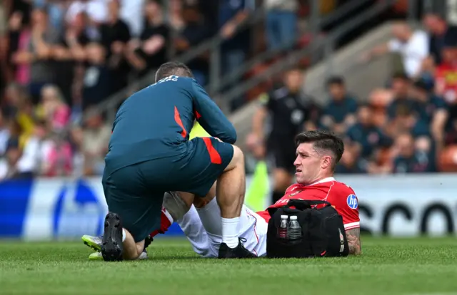 Wrexham's Josh Windass receives treatment foir an injury
