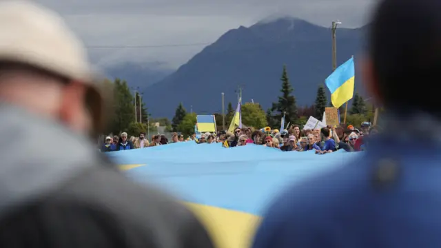 Demonstrators hold a large Ukrainian flag in Anchorage