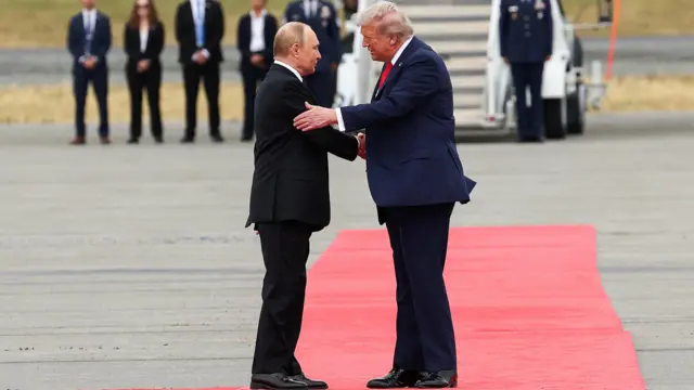 U.S. President Donald Trump shakes hand with Russian President Vladimir Putin