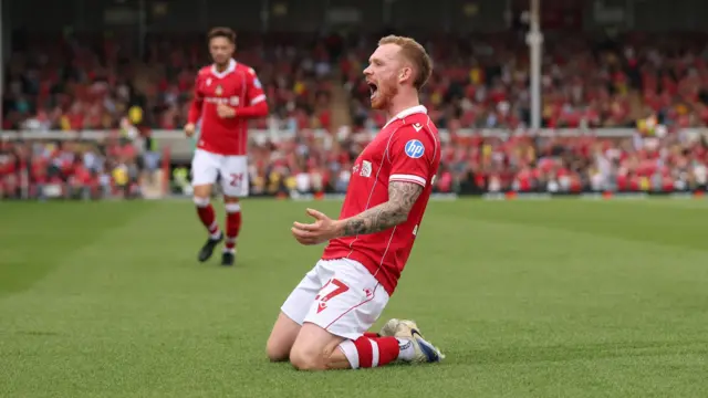 Lewis O'Brien of Wrexham scores a goal and celebrates 1-1.