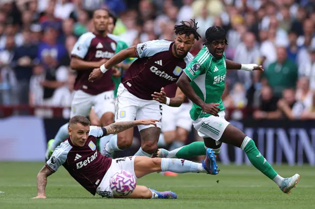 Lucas Digne (C) makes a tackle