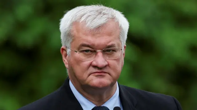 Ukraine's foreign minister wears a suit and looks ahead.