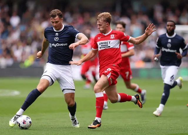 ake Cooper of Millwall is put under pressure by Tommy Conway of Middlesbrough