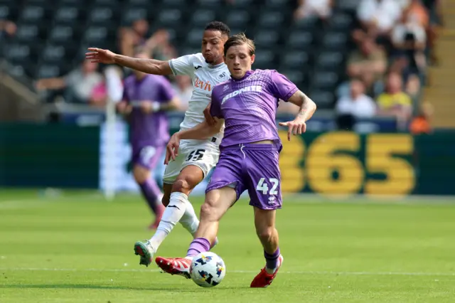 Swansea City's Ronald (left) and Sheffield United's Sydie Peck battle for the ball