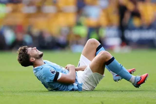 Nico Gonzalez of Manchester City goes down