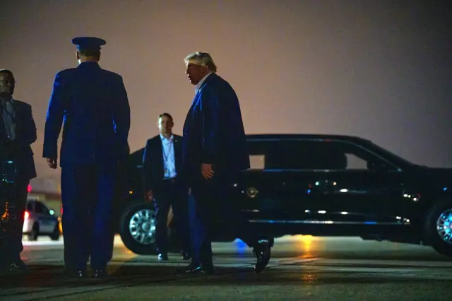 Donald Trump walks towards the car