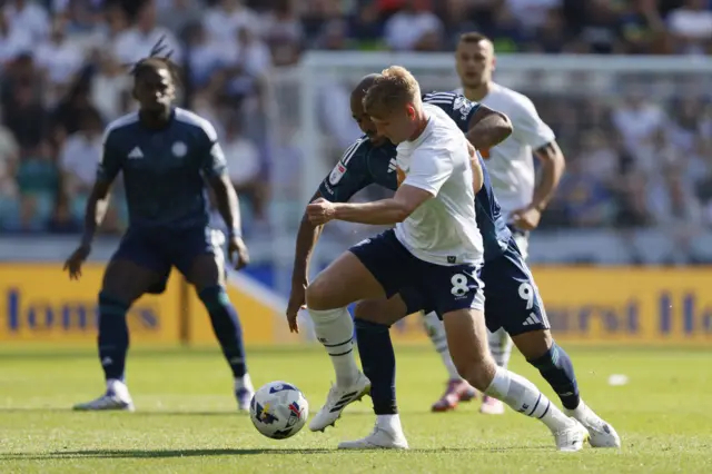 Preston North End's Ali McCann (right) and Leicester City’s Jordan Ayew battle for the ball