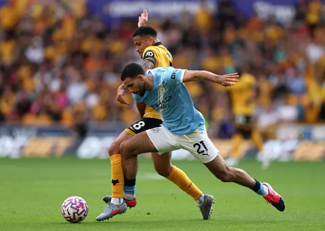 Rayan Ait-Nouri of Manchester City is challenged by Joao Gomes