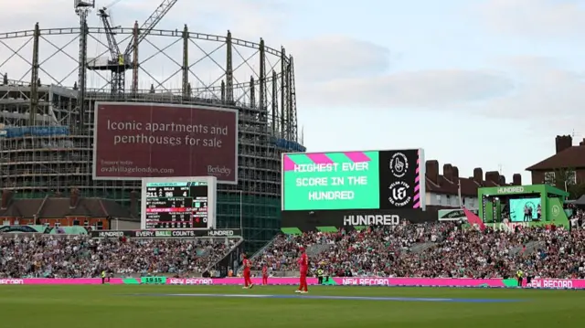 A screen displays the message "highest ever score in the hundred" during the The Hundred match between Oval Invincibles Men and Welsh Fire Men
