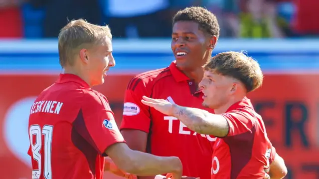 Aberdeen's Leighton Clarkson (R) celebrates with Kusini Yengi (centre) and Topi Keskinen after scoring to make it 3-0 during a Premier Sports Cup Second Round match between Greenock Morton and Aberdeen at Cappielow Park,