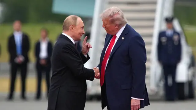 Putin and Trump shake hands