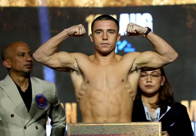 Nick Ball flexing his biceps on the scales