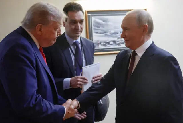 Trump and Putin shaking hands