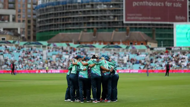 Players of Oval Invincibles gather for a team huddle