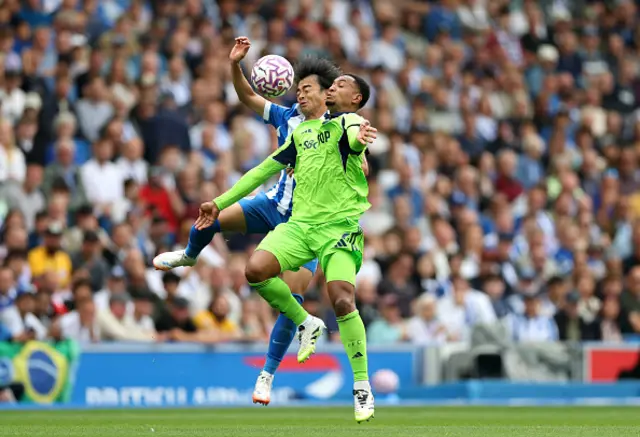 Kaoru Mitoma of Brighton & Hove Albion and Kenny Tete of Fulham compete for a header