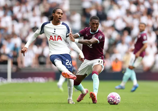 Djed Spence of Tottenham Hotspur battles for possession
