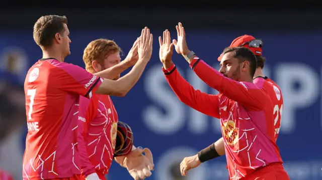 Saif Zaib of Welsh Fire celebrates with teammates after taking the wicket of Tawanda Muyeye