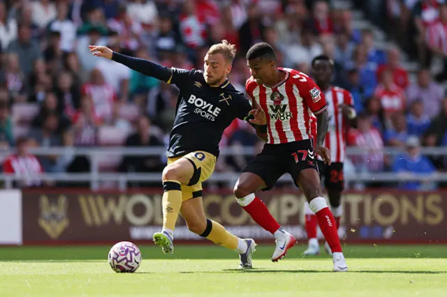 Jarrod Bowen of West Ham United is challenged by Reinildo Mandava