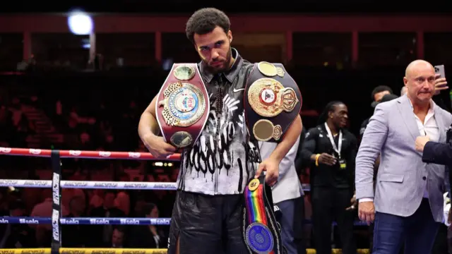 Moses Itauma with his belts after victory