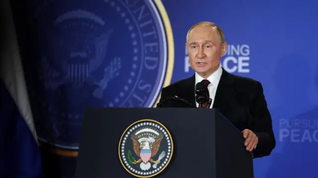 Putin talks at a podium