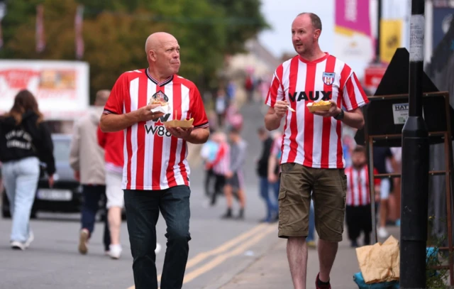 Fans walk to the Stadium of Light