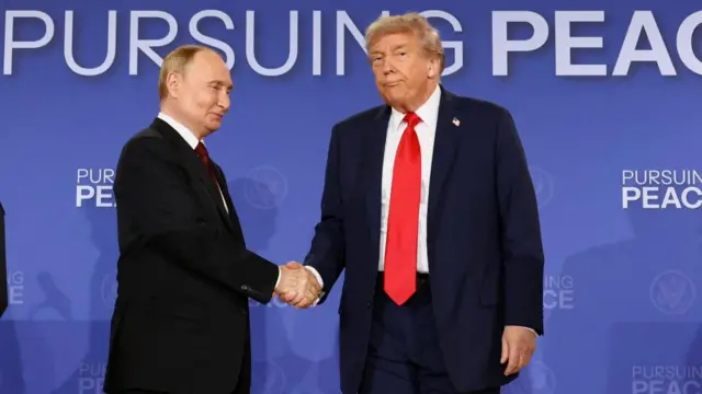 Putin and Trump shake hands in front of a blue background that says pursuing peace