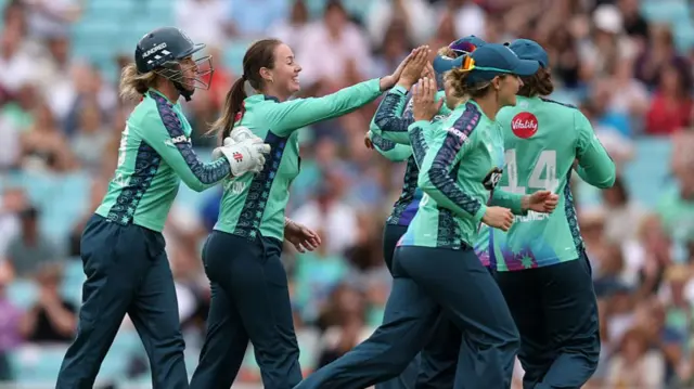 Amanda-Jade Wellington of Oval Invincibles celebrates with teammates after taking the wicket of Hayley Matthews