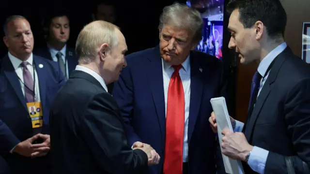Trump and Putin shake hands