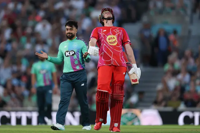 Luke Wells of Welsh Fire reacts as Rashid Khan of Oval Invincibles celebrates taking his wicket