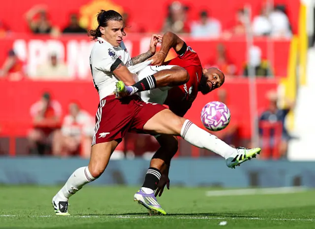Riccardo Calafiori of Arsenal is challenged by Bryan Mbeumo