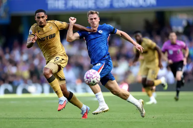 Liam Delap of Chelsea is challenged by Maxence Lacroix