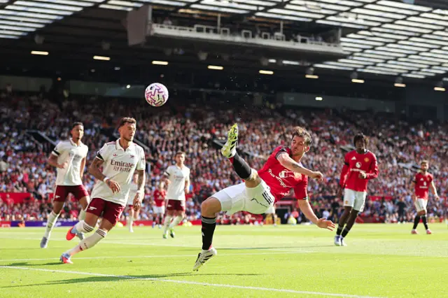 Mason Mount of Manchester United tries an acrobatic shot under pressure from Ben White