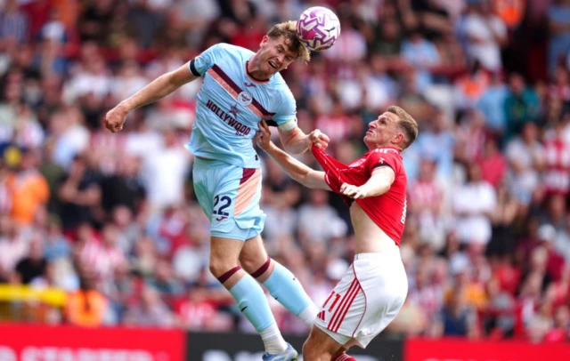 Brentford's Nathan Collins (left) and Nottingham Forest's Chris Wood battle for the ball