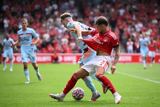 Neco Williams of Nottingham Forest is challenged by Keane Lewis-Potter
