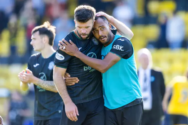 Grant Hanley shares an embrace with Jordan Obita