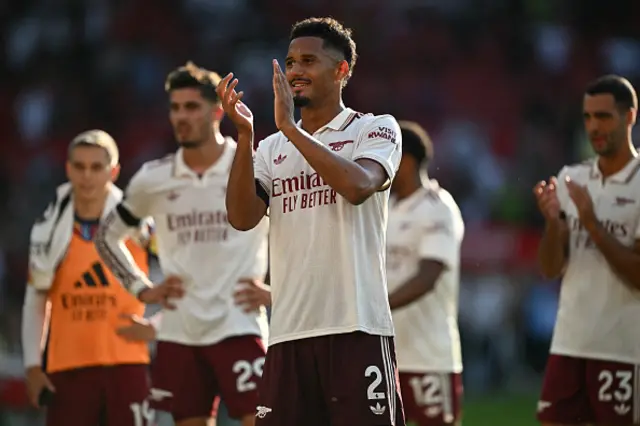 William Saliba applauds fans on the pitch