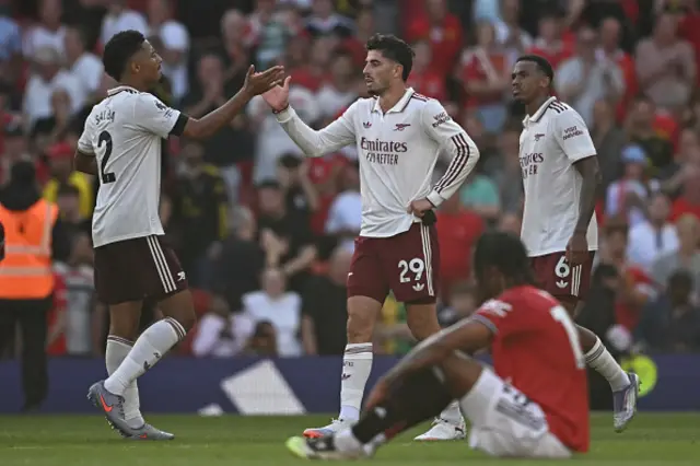 rsenal's French defender William Saliba (L) and Arsenal's German midfielder Kai Havertz (C) shake hands on the final whistle